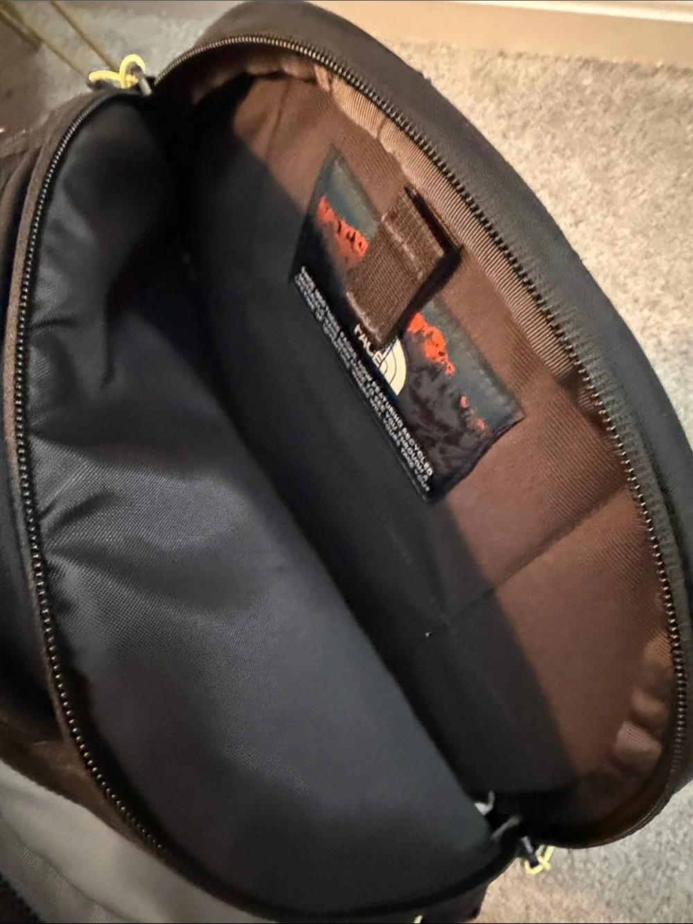 The North Face Black Backpack with Yellow Bungee and Straps